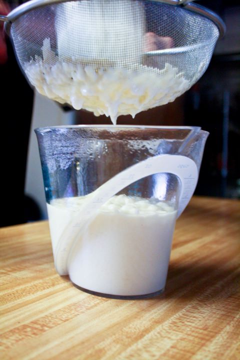 Straining the bechamel sauce.