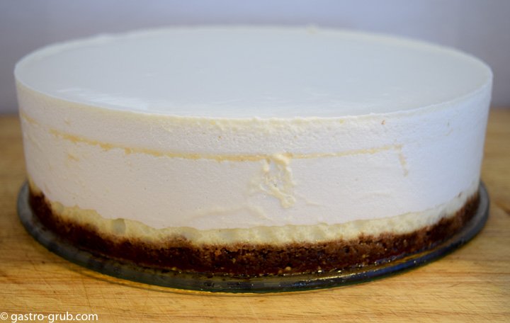 Whole cheesecake on a serving platter.