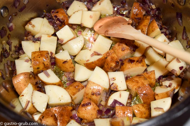 Add the potatoes and cook until the onion is lightly browned.