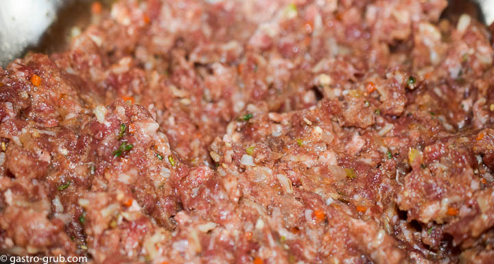 Mixing the meatloaf in a mixing bowl.