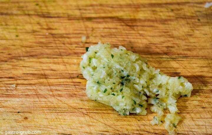 Garlic paste on a cutting board.