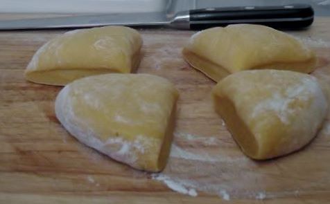 Dividing the pasta to roll it out.