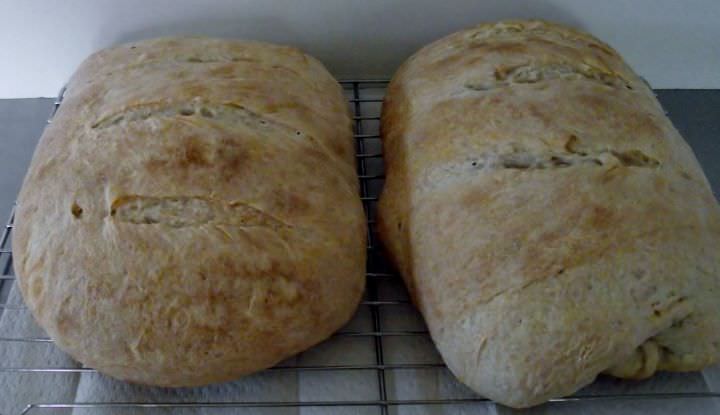 Sourdough bread cooling on a rack.