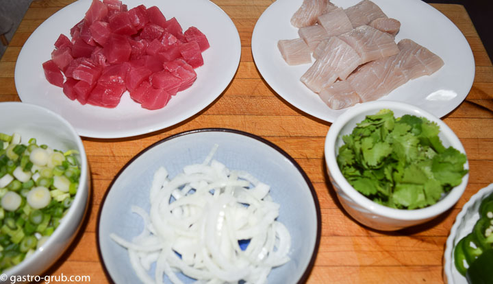 Ingredients for sashimi and poke: ahi tuna, mahi mahi, green onions, white onion, cilantro, and jalapeño peppers.